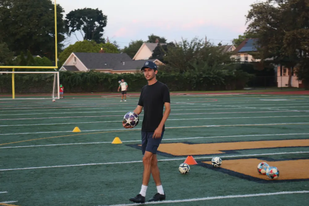 Coach Josh holding a ball at the end of a session